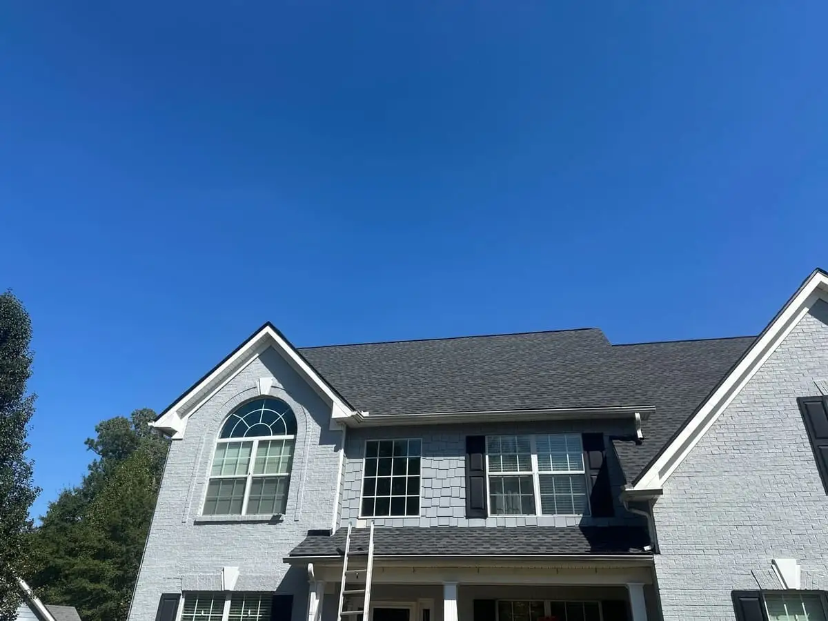 Dark shingle roof on a two-story painted brick home in Sharpsburg, GA