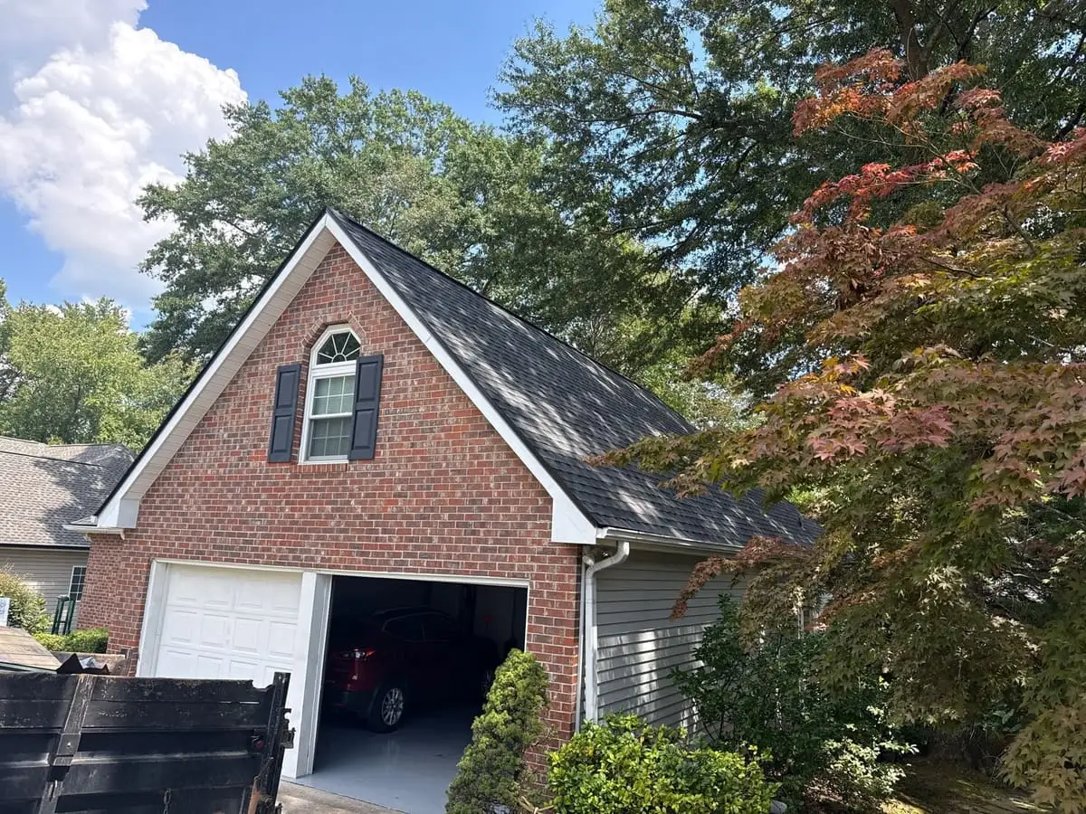 Dark shingle roof on a brick home with a garage in Carrollton, GA