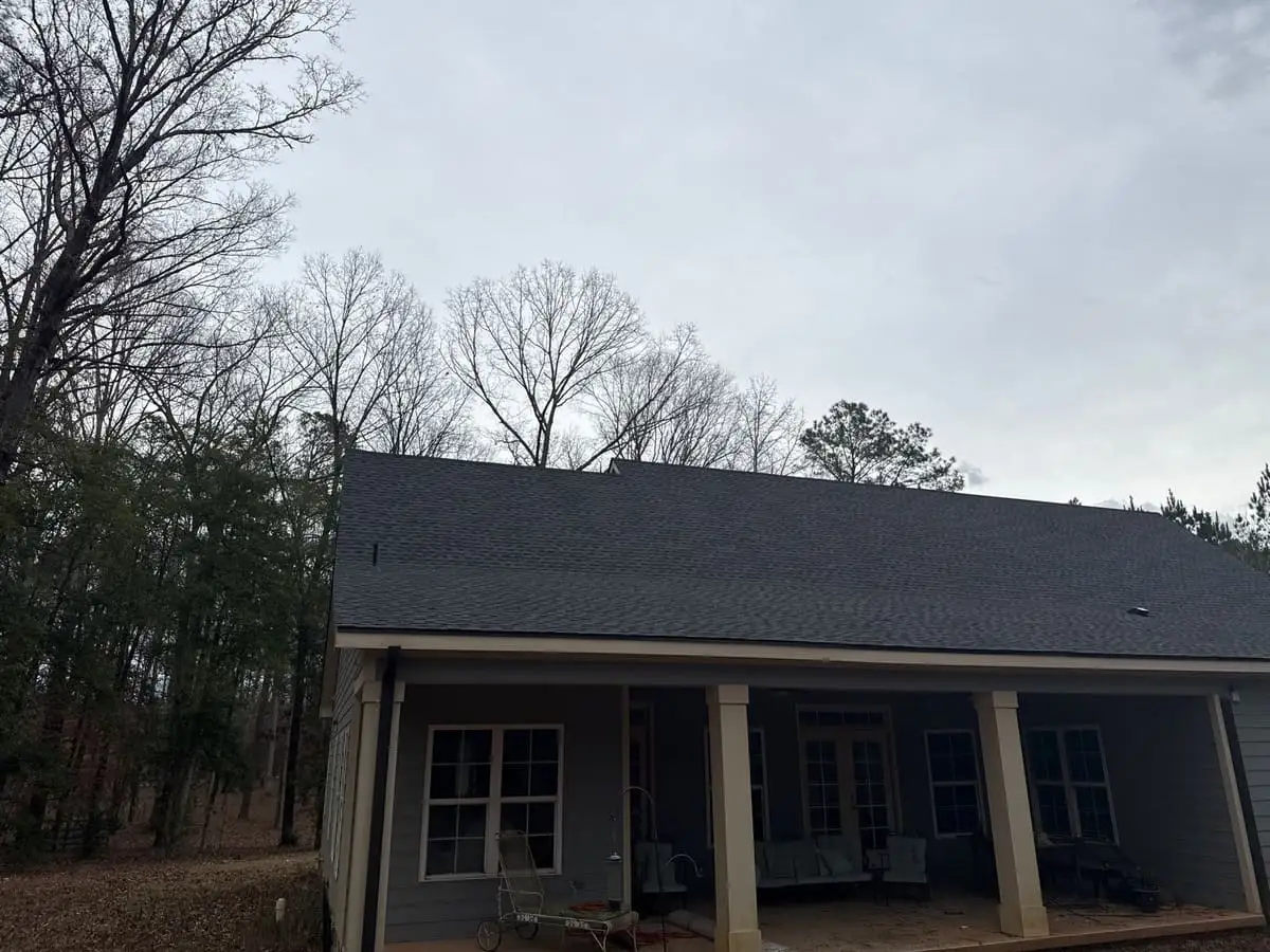 Dark shingle roof over a covered back porch in Brooks, GA