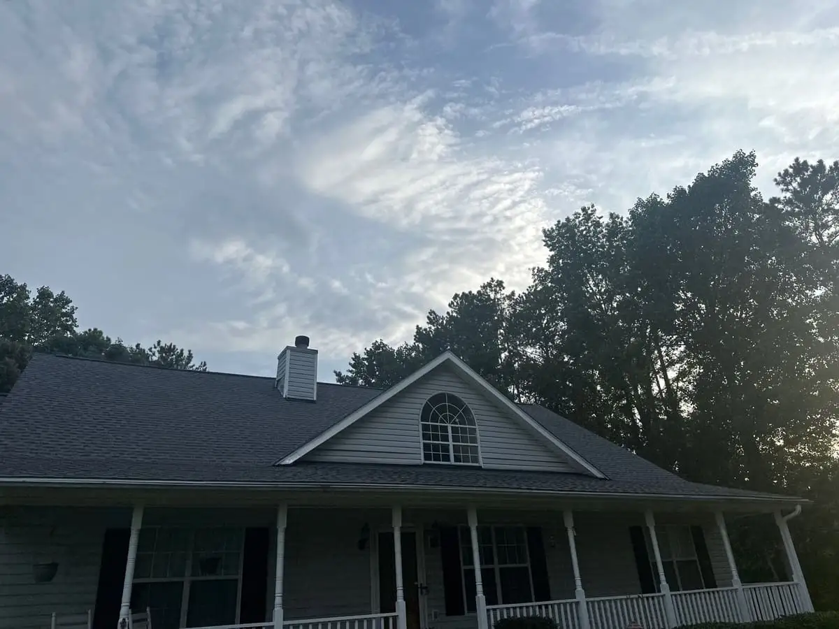 Dark shingle roof over a wraparound porch in Stockbridge, GA