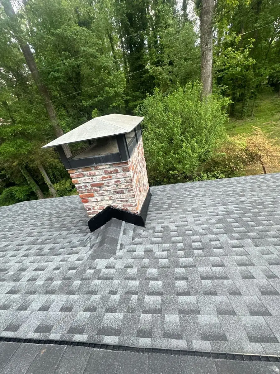 New shingles and chimney flashing on a roof in Stone Mountain, GA