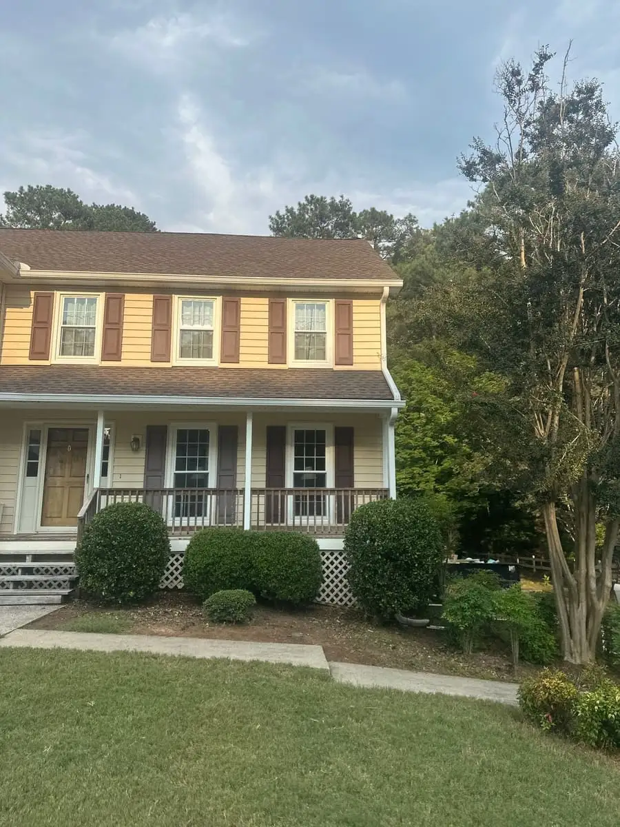 Brown shingle roof on a two-story home with a front porch in Peachtree City, GA