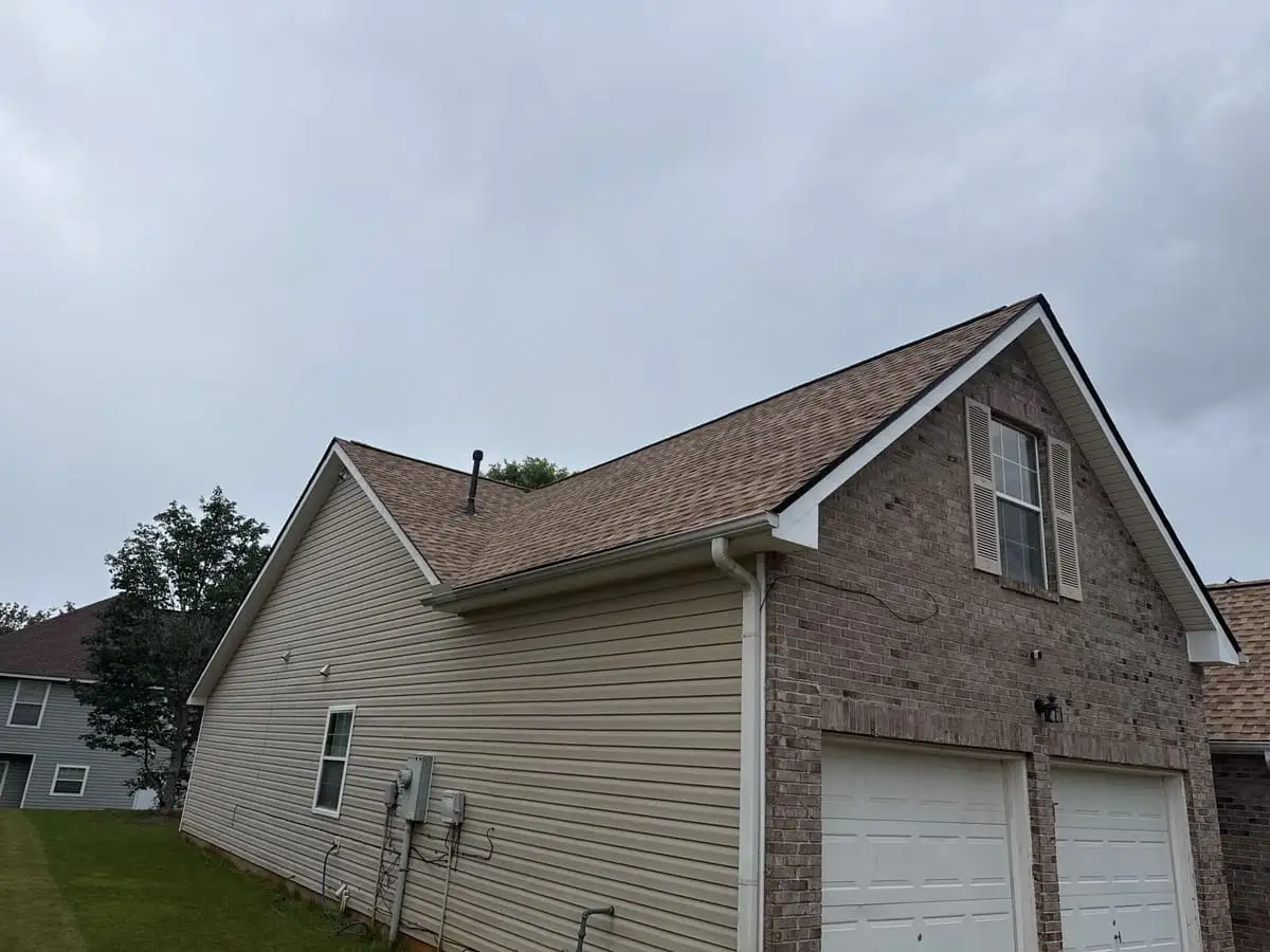 Brown architectural shingle roof on a brick and siding home with a two-car garage in Hampton, GA